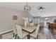 Open dining area with hardwood floors and modern chandelier at 4512 Ulster Ave, North Port, FL 34287