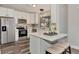 Well-lit kitchen featuring modern white cabinets, stainless steel appliances, and a breakfast bar at 4512 Ulster Ave, North Port, FL 34287