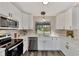Bright and modern kitchen with stainless steel appliances and white cabinets at 4512 Ulster Ave, North Port, FL 34287