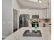 Well-lit kitchen featuring modern white cabinets, stainless steel appliances, and a skylight at 4512 Ulster Ave, North Port, FL 34287