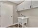Functional laundry area with a utility sink, white cabinetry, and a convenient access door at 4512 Ulster Ave, North Port, FL 34287