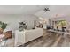 Spacious living room featuring sleek, modern wood floors flowing into an open kitchen and dining area at 4512 Ulster Ave, North Port, FL 34287