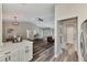 Open-concept living room showcasing hardwood floors, modern lighting, and seamless transition to the dining area at 4512 Ulster Ave, North Port, FL 34287