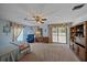 Spacious bedroom with large windows, ceiling fan, and ample closet space at 4674 Hidden River Rd, Sarasota, FL 34240