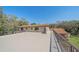Expansive rooftop deck showcasing the home's exterior and tranquil landscape at 4674 Hidden River Rd, Sarasota, FL 34240