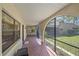 Covered porch with terracotta tile flooring and screens at 4674 Hidden River Rd, Sarasota, FL 34240