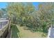 Private backyard featuring a tranquil wooded area and grassy lawn at 4674 Hidden River Rd, Sarasota, FL 34240