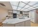 Modern kitchen with granite countertops and an island at 4674 Hidden River Rd, Sarasota, FL 34240