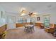Bright dining area with wood paneling, a table, chairs, and large windows at 4674 Hidden River Rd, Sarasota, FL 34240