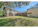 Backyard view of the two-story home showcasing a large lawn at 4674 Hidden River Rd, Sarasota, FL 34240