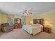 Bright bedroom featuring a king-size bed, dresser, and armchair at 4674 Hidden River Rd, Sarasota, FL 34240