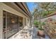 Sliding glass door opens to a peaceful patio with stone wall at 4674 Hidden River Rd, Sarasota, FL 34240