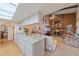 Open kitchen with granite island and view into living room with fireplace at 4674 Hidden River Rd, Sarasota, FL 34240