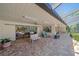 Spacious covered patio with seating area, overlooking the pool and lush landscaping at 4674 Hidden River Rd, Sarasota, FL 34240
