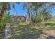 Landscaped backyard with stone retaining walls and lush greenery at 4674 Hidden River Rd, Sarasota, FL 34240