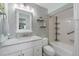 Bathroom with decorative wallpaper, granite countertop, and updated fixtures at 1647 Southwood St # 1647, Sarasota, FL 34231