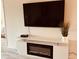Living room with built-in electric fireplace and large TV at 4640 Tower Hill Ln # 2322, Sarasota, FL 34238