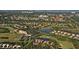 Aerial view of community with houses, golf course, and water at 4640 Tower Hill Ln # 2322, Sarasota, FL 34238