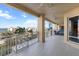 Large, covered balcony featuring tiled floors, seating, and scenic waterfront views at 35 Watergate Dr # 503, Sarasota, FL 34236