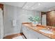 This luxurious bathroom has marble accents, double sinks, and a large mirror at 35 Watergate Dr # 503, Sarasota, FL 34236
