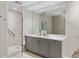Bright bathroom featuring gray cabinetry, marble countertops, and a glass enclosed shower at 35 Watergate Dr # 503, Sarasota, FL 34236