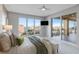 Bright bedroom with a water view, access to a balcony, and neutral decor at 35 Watergate Dr # 503, Sarasota, FL 34236