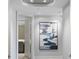 Bright hallway with recessed lighting and a modern art piece leading to a kitchen at 35 Watergate Dr # 503, Sarasota, FL 34236