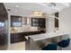 Modern kitchen with stainless steel appliances, tiled backsplash, and breakfast bar at 35 Watergate Dr # 503, Sarasota, FL 34236