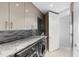 This laundry room has front loading washer and dryer, cabinets and a granite countertop at 35 Watergate Dr # 503, Sarasota, FL 34236