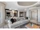 Bright and open living room with tray ceiling, tile floors, large windows, and modern furnishings at 35 Watergate Dr # 503, Sarasota, FL 34236