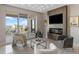 Bright living room features modern fireplace, flat screen tv, and balcony access at 35 Watergate Dr # 503, Sarasota, FL 34236