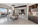 Dining and living space with floor-to-ceiling windows, fireplace, and open bar area at 35 Watergate Dr # 503, Sarasota, FL 34236