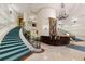 Elegant building lobby with winding staircase, chandelier, marble floors, and reception desk at 35 Watergate Dr # 503, Sarasota, FL 34236