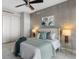 This bedroom is decorated with art and lamps and has a ceiling fan at 35 Watergate Dr # 503, Sarasota, FL 34236