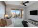 This bedroom features a ceiling fan, a view to the outside, and a flat screen television at 35 Watergate Dr # 503, Sarasota, FL 34236