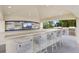 A pool bar with bar seating, TVs, and barbecues offers a convenient poolside entertainment area at 35 Watergate Dr # 503, Sarasota, FL 34236