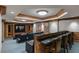 This theater room features a bar, movie posters, a coffered ceiling with pot lights, and comfortable seating at 35 Watergate Dr # 503, Sarasota, FL 34236