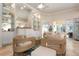 Comfortable living room featuring wicker furniture and built-in shelving at 5814 Benevento Dr, Sarasota, FL 34238