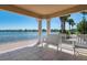 Community patio with a lake view and white benches at 5814 Benevento Dr, Sarasota, FL 34238
