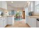 Bright kitchen with white cabinets, tile floor, and breakfast nook at 5814 Benevento Dr, Sarasota, FL 34238