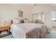 Guest bedroom with twin beds, wicker furniture, and mirrored closet at 5814 Benevento Dr, Sarasota, FL 34238