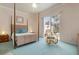 Main bedroom with a four-poster bed and sliding glass doors to patio at 5814 Benevento Dr, Sarasota, FL 34238