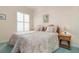 Guest bedroom with twin beds, wicker furniture, and window seat at 5814 Benevento Dr, Sarasota, FL 34238