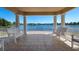 Covered gazebo with white benches overlooking a lake at 5814 Benevento Dr, Sarasota, FL 34238