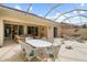Spacious covered patio with wicker furniture and dining table, overlooking the pool at 5814 Benevento Dr, Sarasota, FL 34238