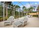 Spacious patio with wicker seating and tropical views at 5814 Benevento Dr, Sarasota, FL 34238