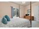 Bedroom with a four-poster bed and sliding glass doors to the patio at 5814 Benevento Dr, Sarasota, FL 34238