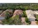 House situated in a community with lush landscaping and a pond at 5814 Benevento Dr, Sarasota, FL 34238