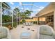 Relax on this screened patio with lush landscaping at 5814 Benevento Dr, Sarasota, FL 34238