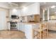 Spacious kitchen with white cabinets, stainless steel appliances, and an island with seating at 5814 Benevento Dr, Sarasota, FL 34238
